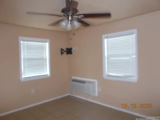 a view of a livingroom with a ceiling fan and a window