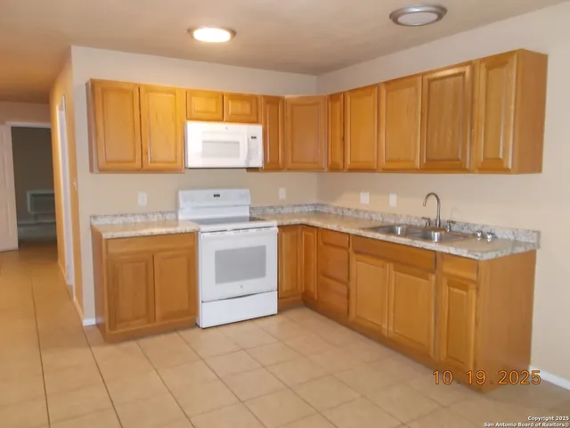 a kitchen with a sink stove and cabinets