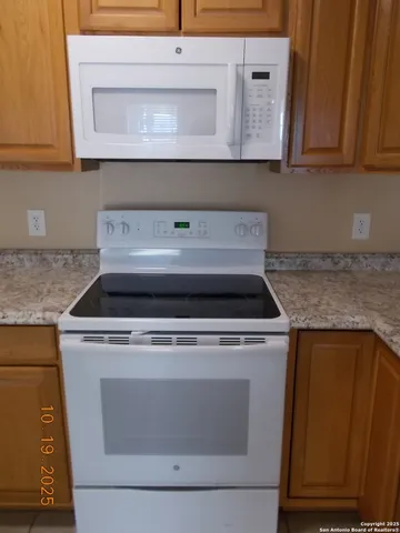 a stove top oven sitting inside of a kitchen