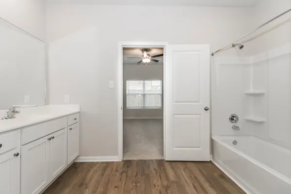 a bathroom with a bathtub and a sink
