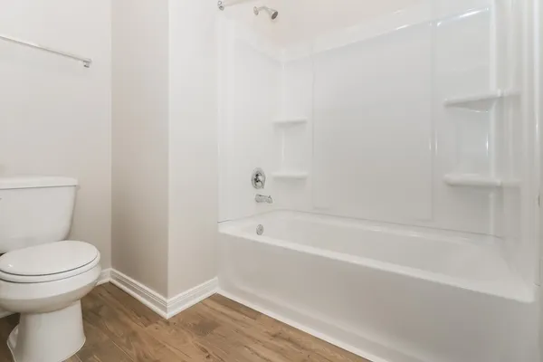 a bathroom with a toilet and bathtub