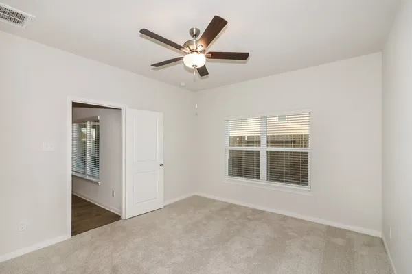 an empty room with windows and closet
