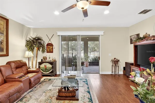 a kitchen with stainless steel appliances kitchen island granite countertop a dining table chairs and granite counter tops