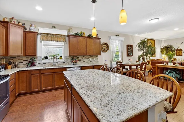 a spacious bathroom with a granite countertop sink a toilet and a mirror