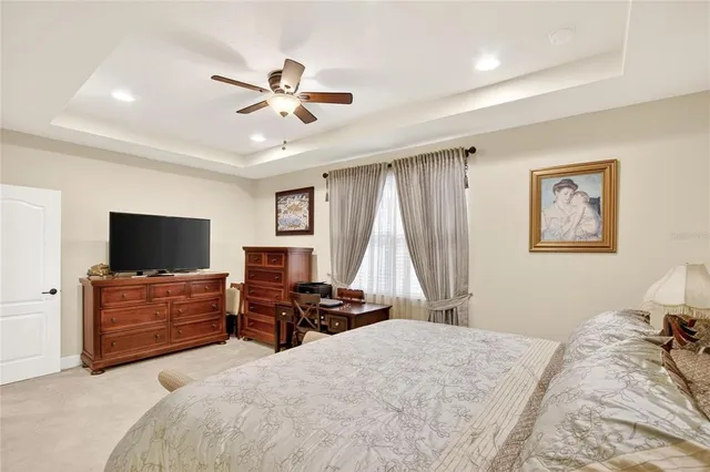 a living room with furniture and a ceiling fan
