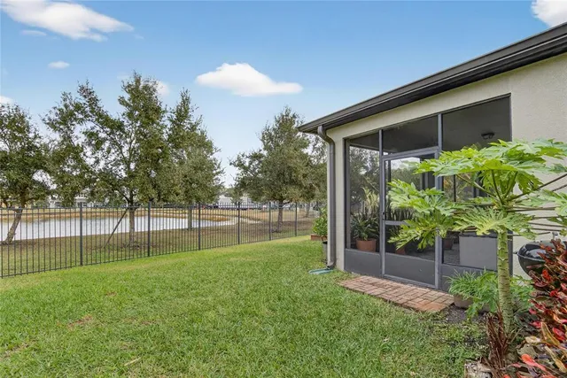an aerial view of a house with swimming pool garden and patio