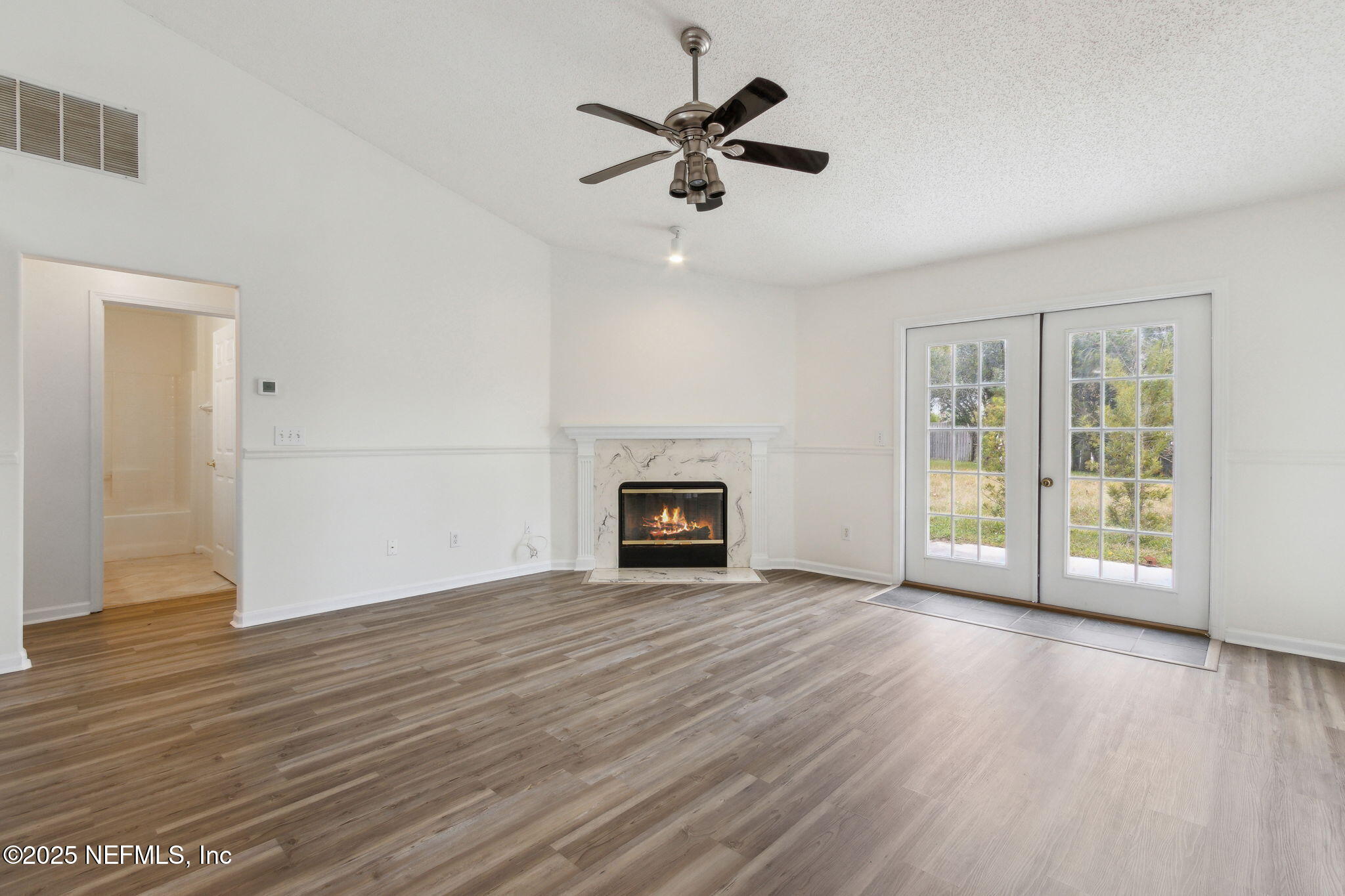 2005 Frogmore Drive Middleburg, FL 32068 - Photo 13 of 43 an empty room with wooden floor fan and windows