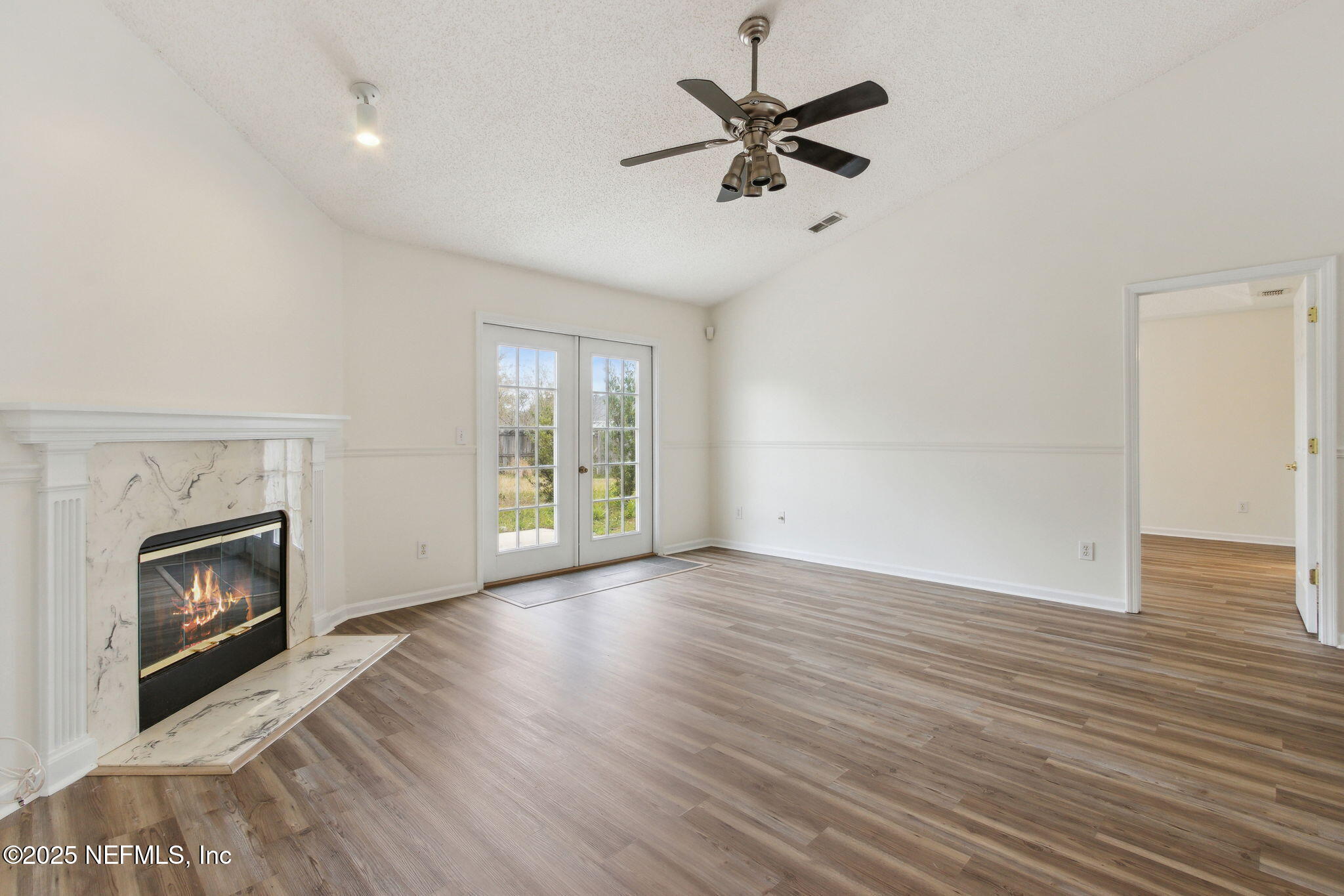2005 Frogmore Drive Middleburg, FL 32068 - Photo 14 of 43 a view of an empty room with a fireplace and a window