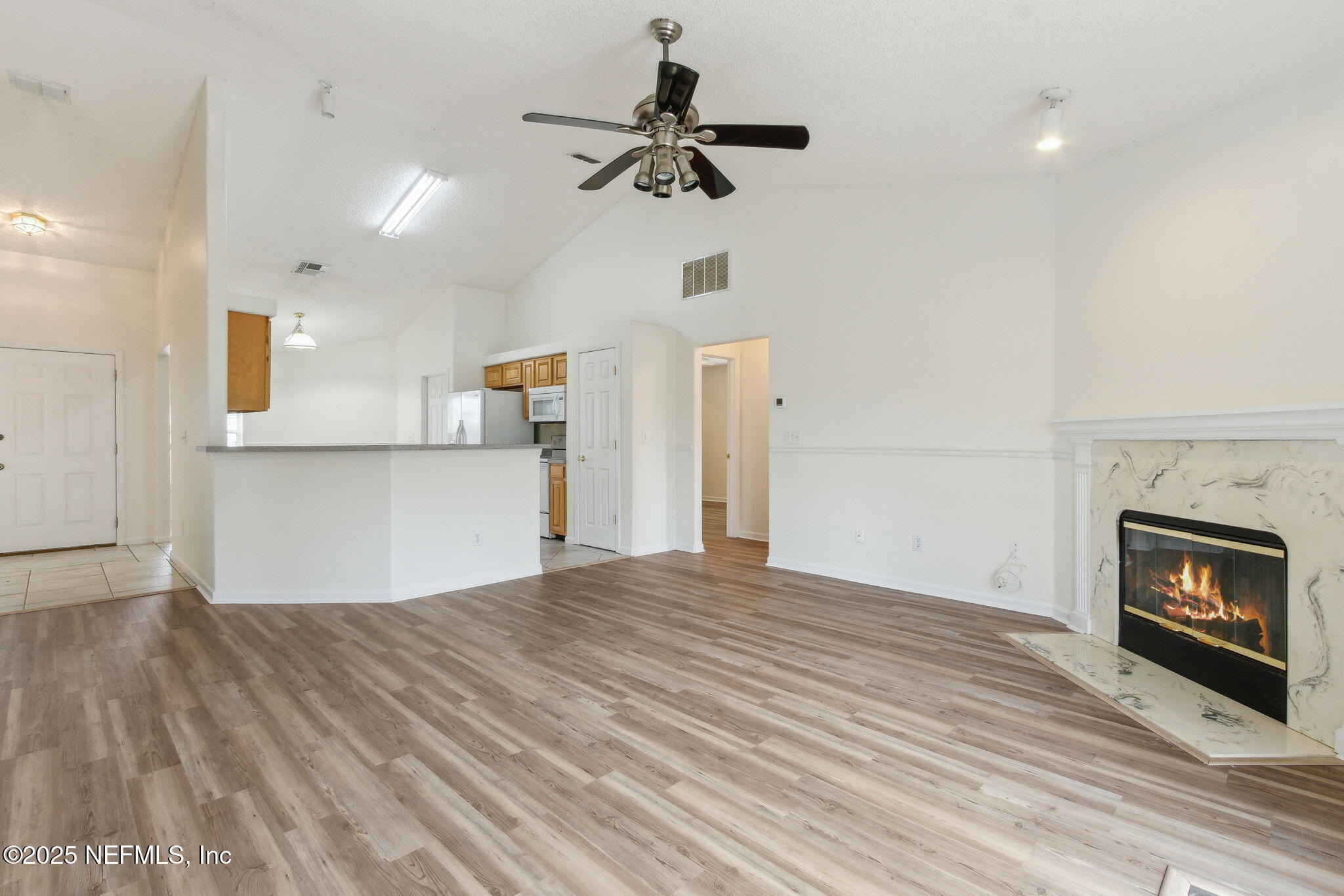 2005 Frogmore Drive Middleburg, FL 32068 - Photo 15 of 43 a view of empty room with wooden floor and kitchen view