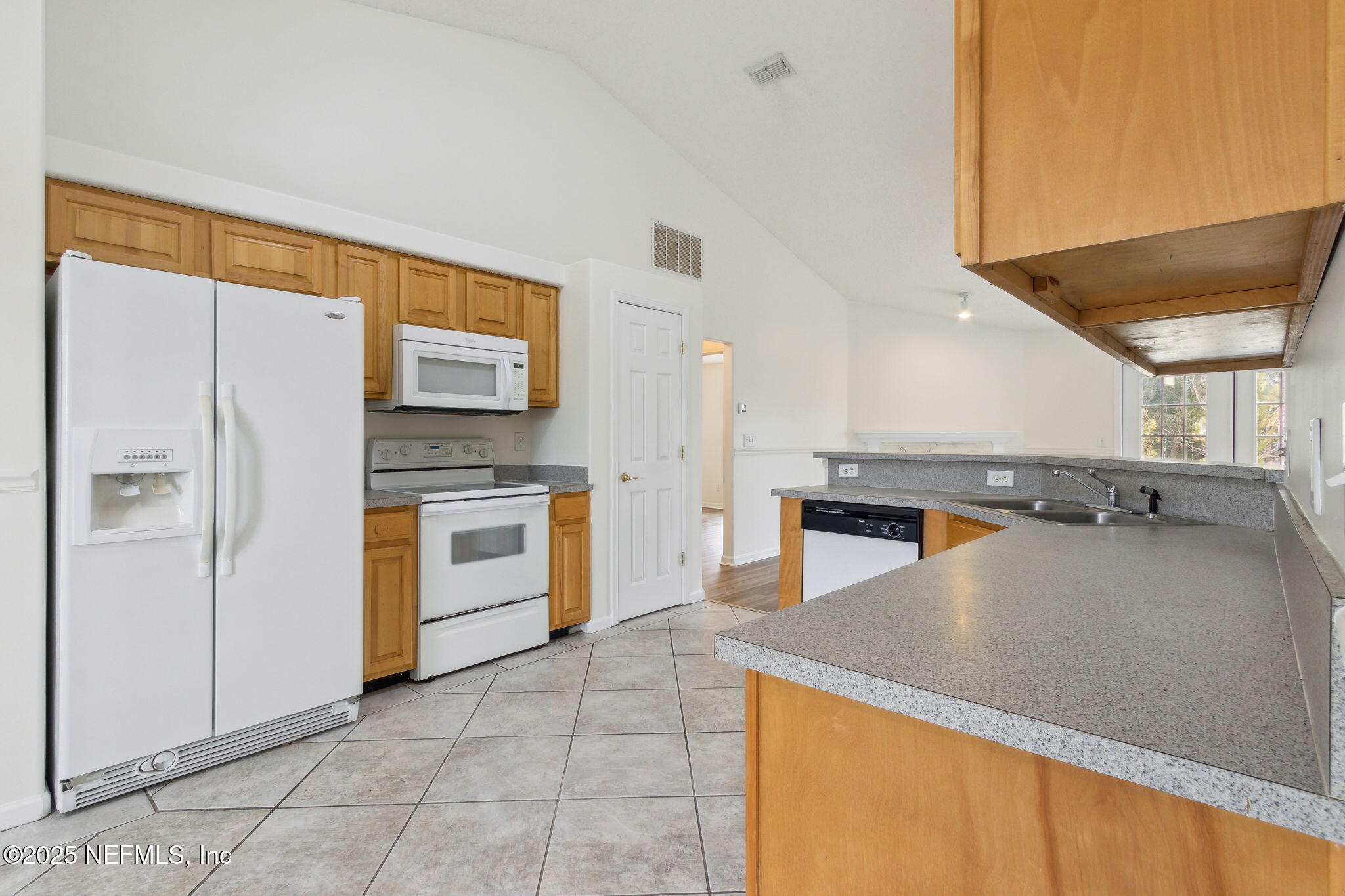 2005 Frogmore Drive Middleburg, FL 32068 - Photo 17 of 43 a kitchen with stainless steel appliances granite countertop a refrigerator a stove and a sink