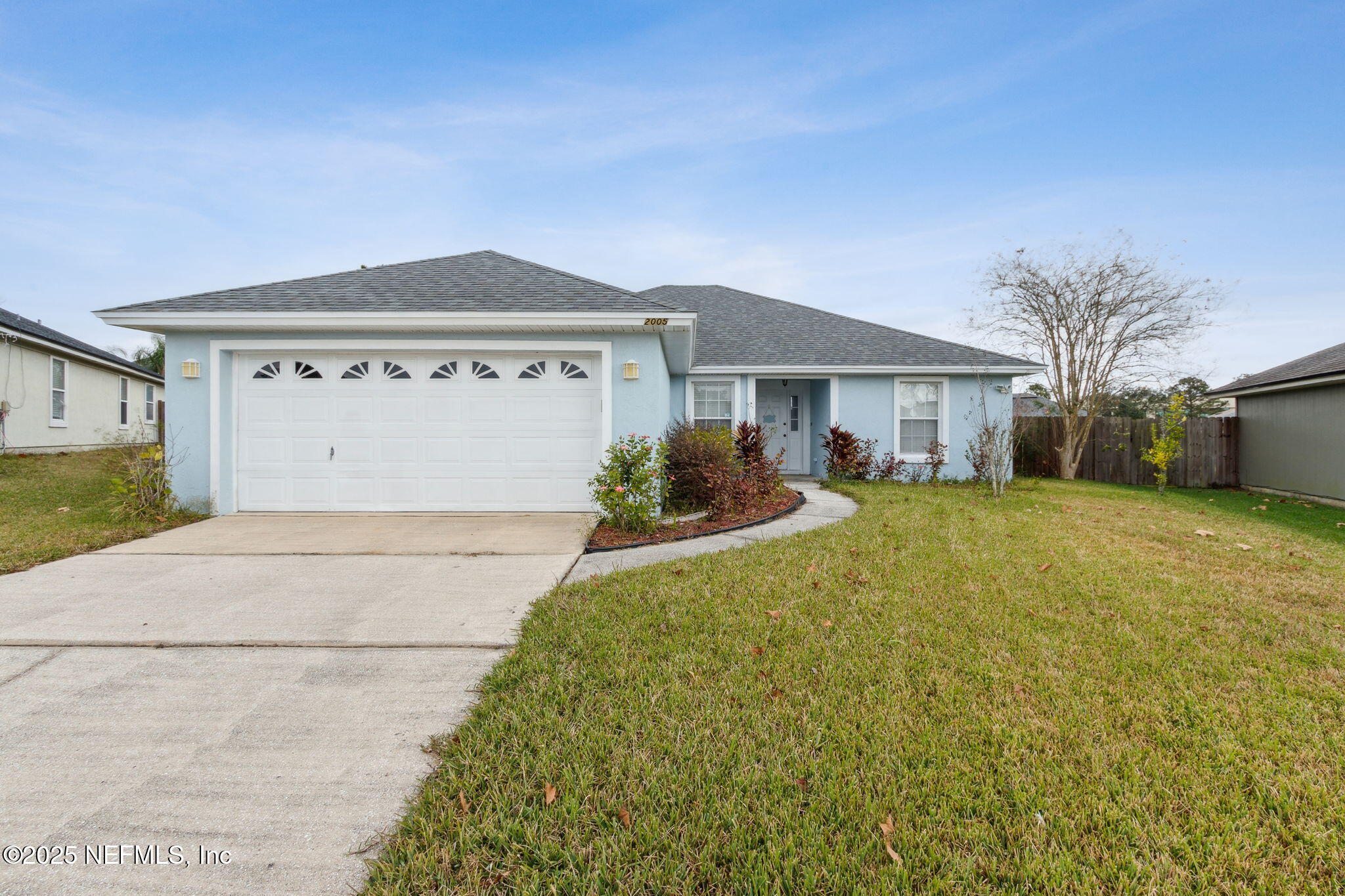 2005 Frogmore Drive Middleburg, FL 32068 - Photo 2 of 43 a front view of a house with a yard and garage