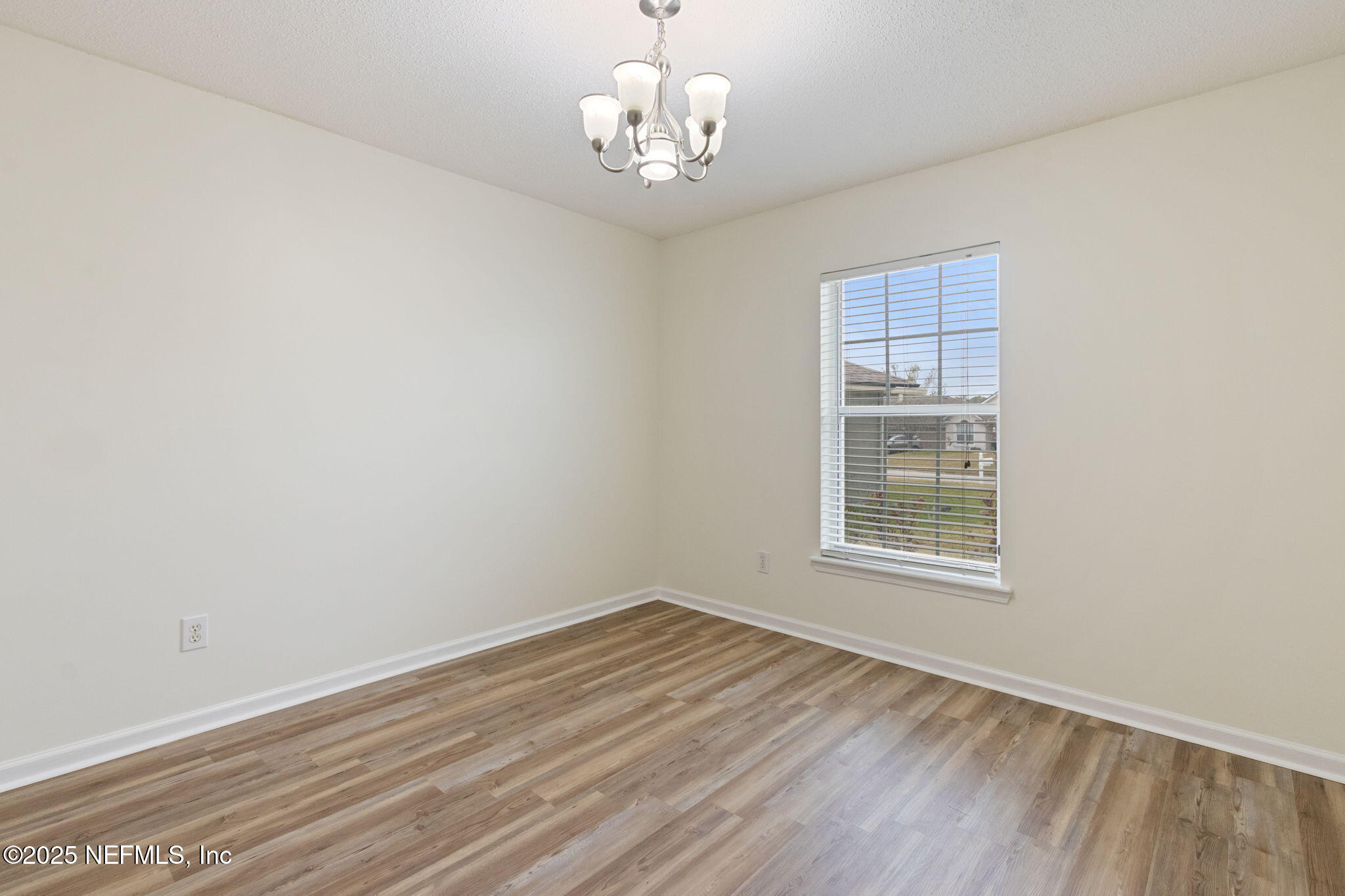 2005 Frogmore Drive Middleburg, FL 32068 - Photo 22 of 43 wooden floor in an empty room with a window