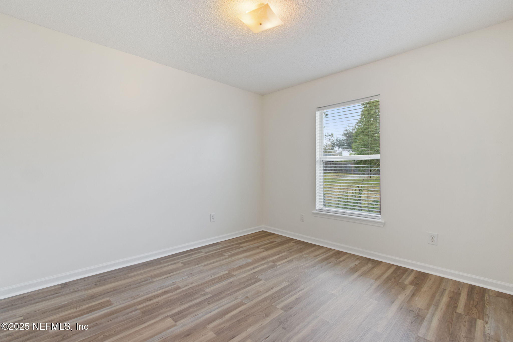 2005 Frogmore Drive Middleburg, FL 32068 - Photo 26 of 43 an empty room with wooden floor and windows