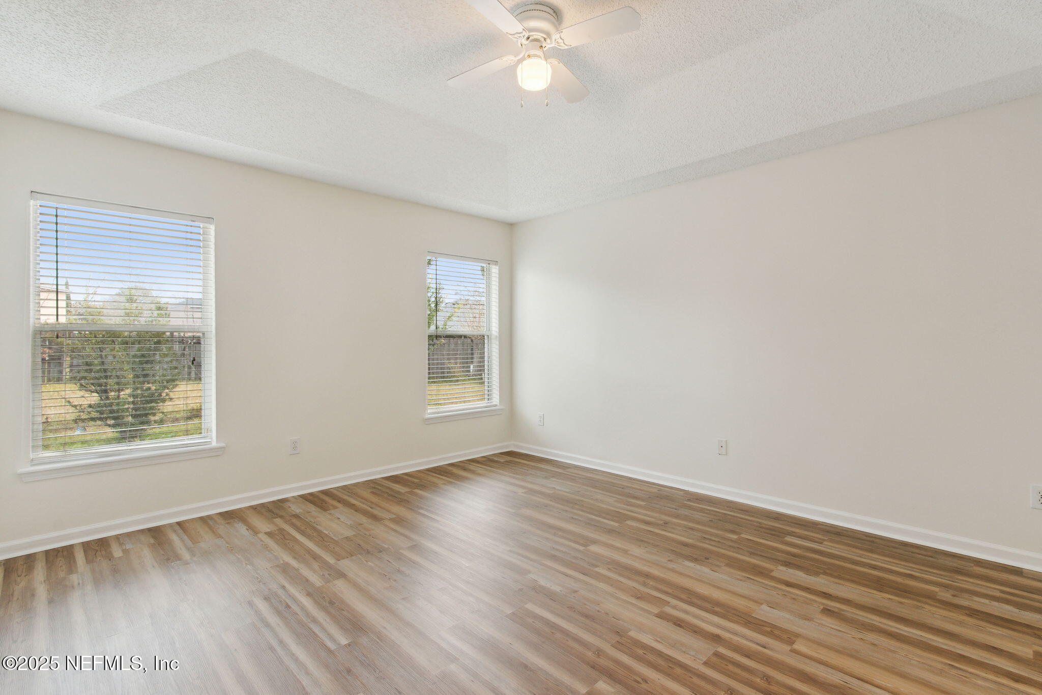 2005 Frogmore Drive Middleburg, FL 32068 - Photo 27 of 43 an empty room with wooden floor and windows