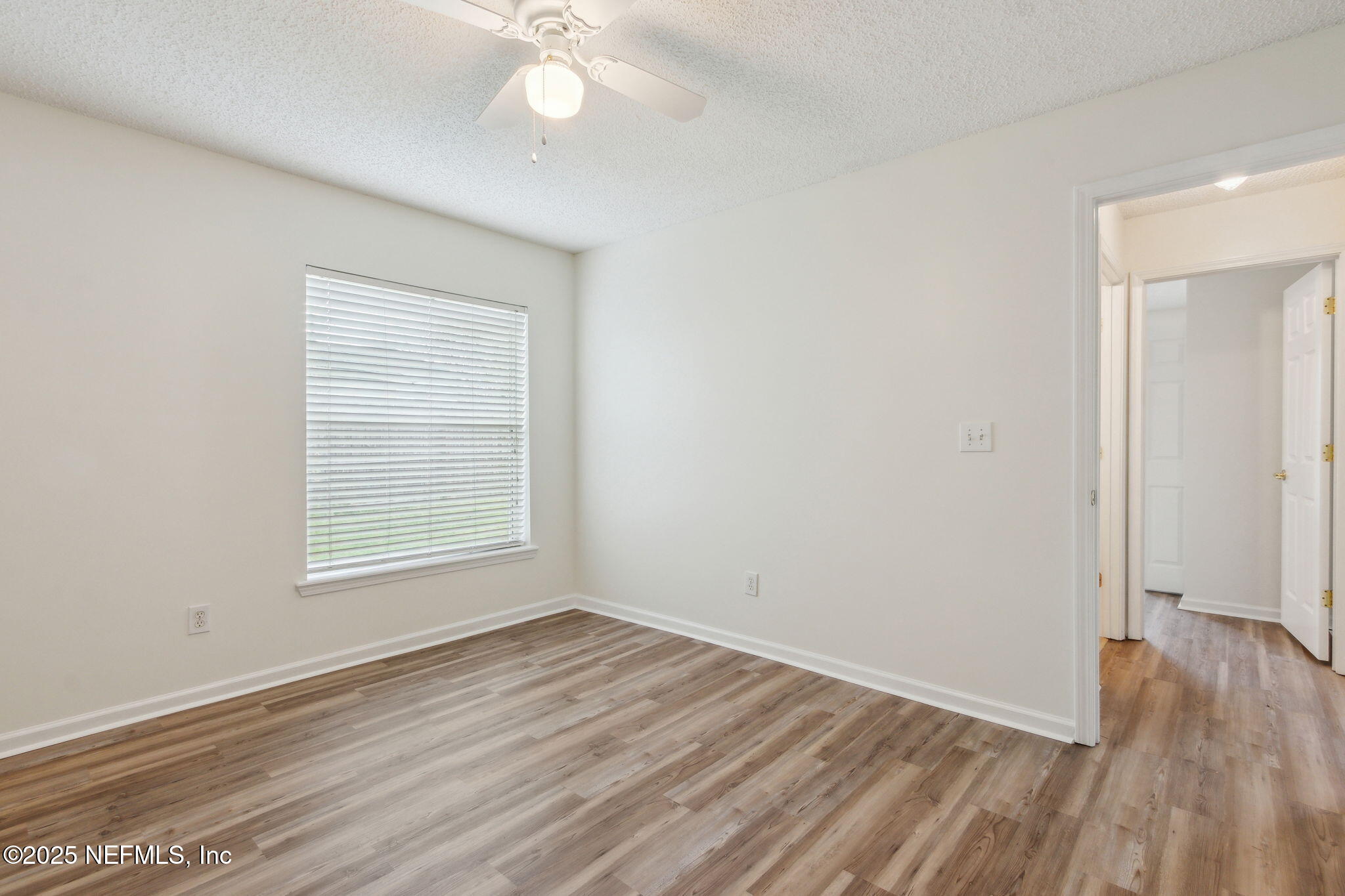 2005 Frogmore Drive Middleburg, FL 32068 - Photo 35 of 43 an empty room with wooden floor and windows