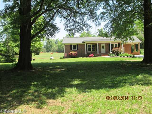 8346 Prince Edward Road Stokesdale, NC 27357 - Photo 1 of 16 Exterior Front. Beautiful big trees provide plenty of shade on the front of the home.