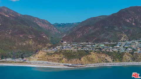 a view of a water with a mountain in the background