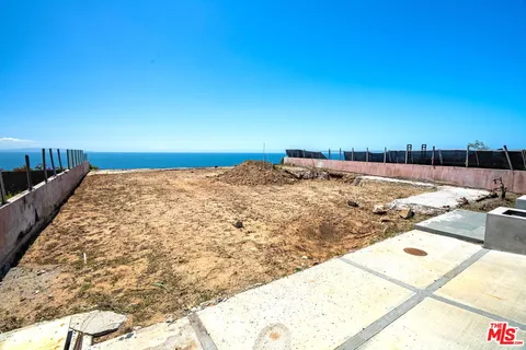 a view of a backyard of the house