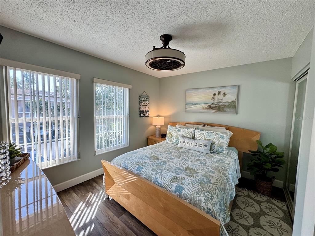 6527 Spring Flower Drive, Unit 21 New Port Richey, FL 34653 - Photo 14 of 21 a bedroom with a bed and a large window