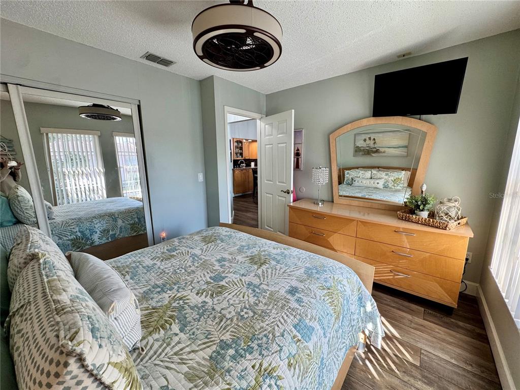 6527 Spring Flower Drive, Unit 21 New Port Richey, FL 34653 - Photo 15 of 21 a bedroom with a bed and wooden floor