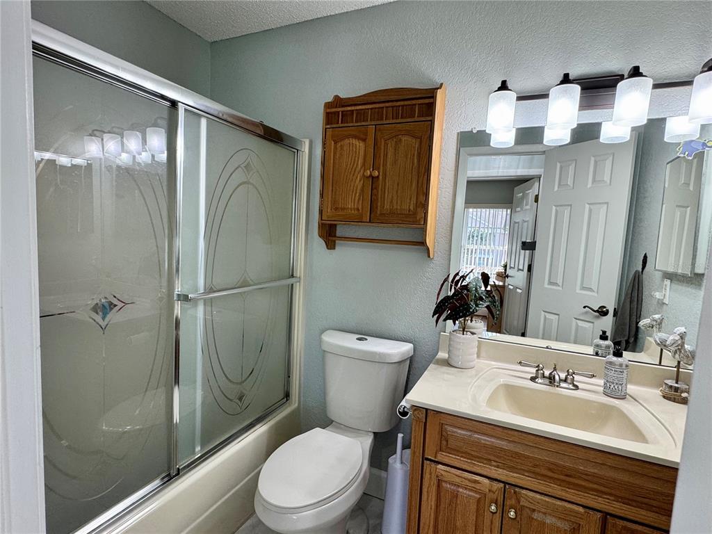 6527 Spring Flower Drive, Unit 21 New Port Richey, FL 34653 - Photo 16 of 21 a bathroom with a sink a toilet and shower