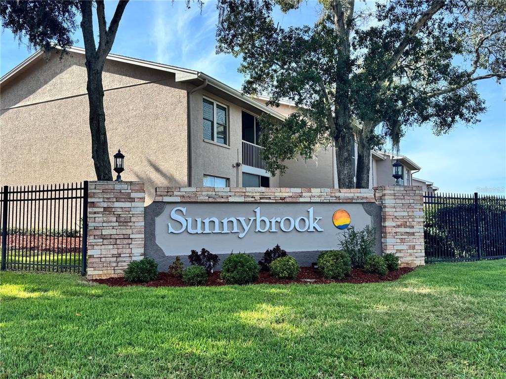 6527 Spring Flower Drive, Unit 21 New Port Richey, FL 34653 - Photo 3 of 21 a sign on the side of a building