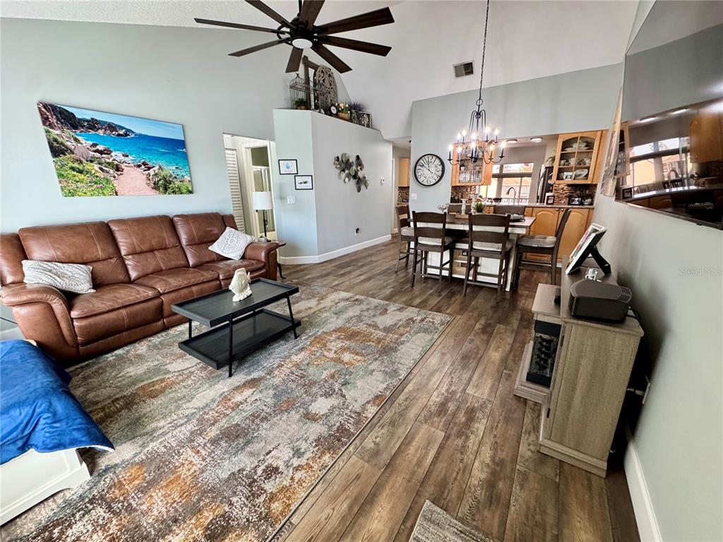 6527 Spring Flower Drive, Unit 21 New Port Richey, FL 34653 - Photo 4 of 21 a living room with furniture and a wooden floor