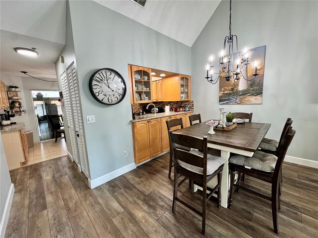 6527 Spring Flower Drive, Unit 21 New Port Richey, FL 34653 - Photo 5 of 21 a view of a dining room with furniture wooden floor and a chandelier