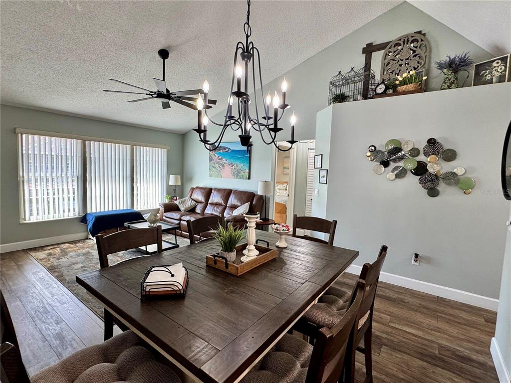 6527 Spring Flower Drive, Unit 21 New Port Richey, FL 34653 - Photo 7 of 21 a view of a dining room with furniture and wooden floor
