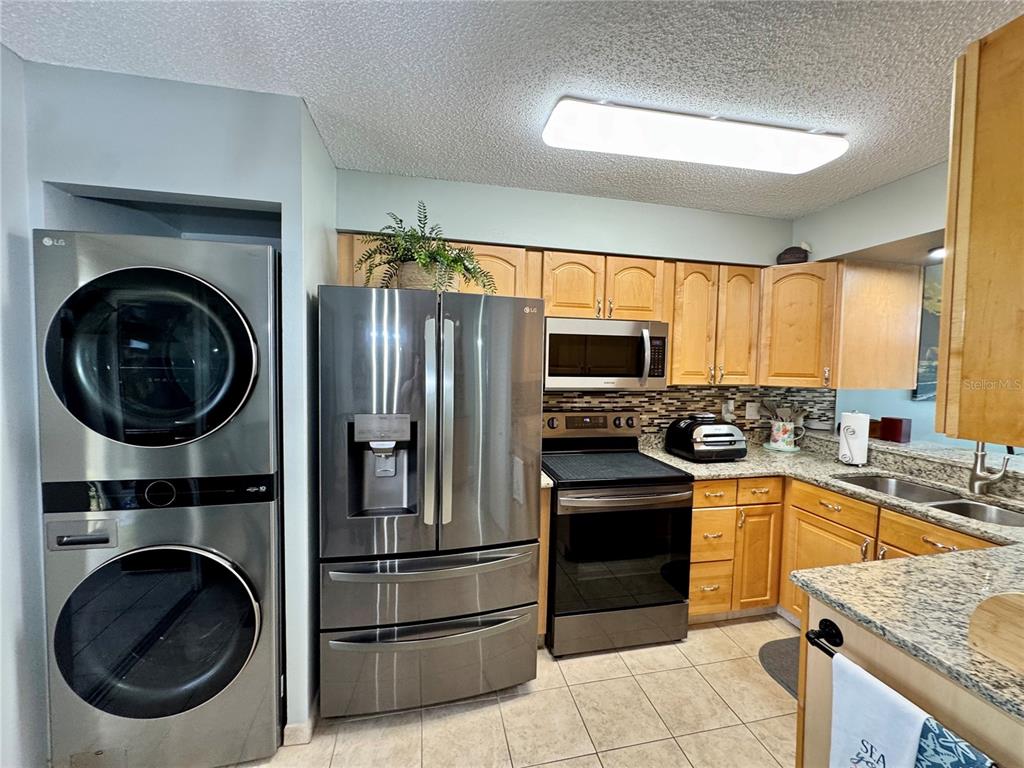6527 Spring Flower Drive, Unit 21 New Port Richey, FL 34653 - Photo 8 of 21 a kitchen with a stove a sink and a refrigerator