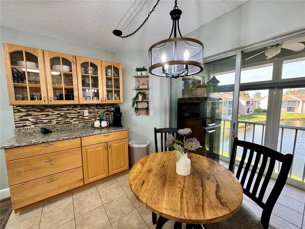 6527 Spring Flower Drive, Unit 21 New Port Richey, FL 34653 - Photo 9 of 21 a view of a dining room with furniture wooden floor and chandelier