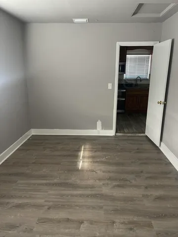 a view of livingroom with kitchen and wooden floor