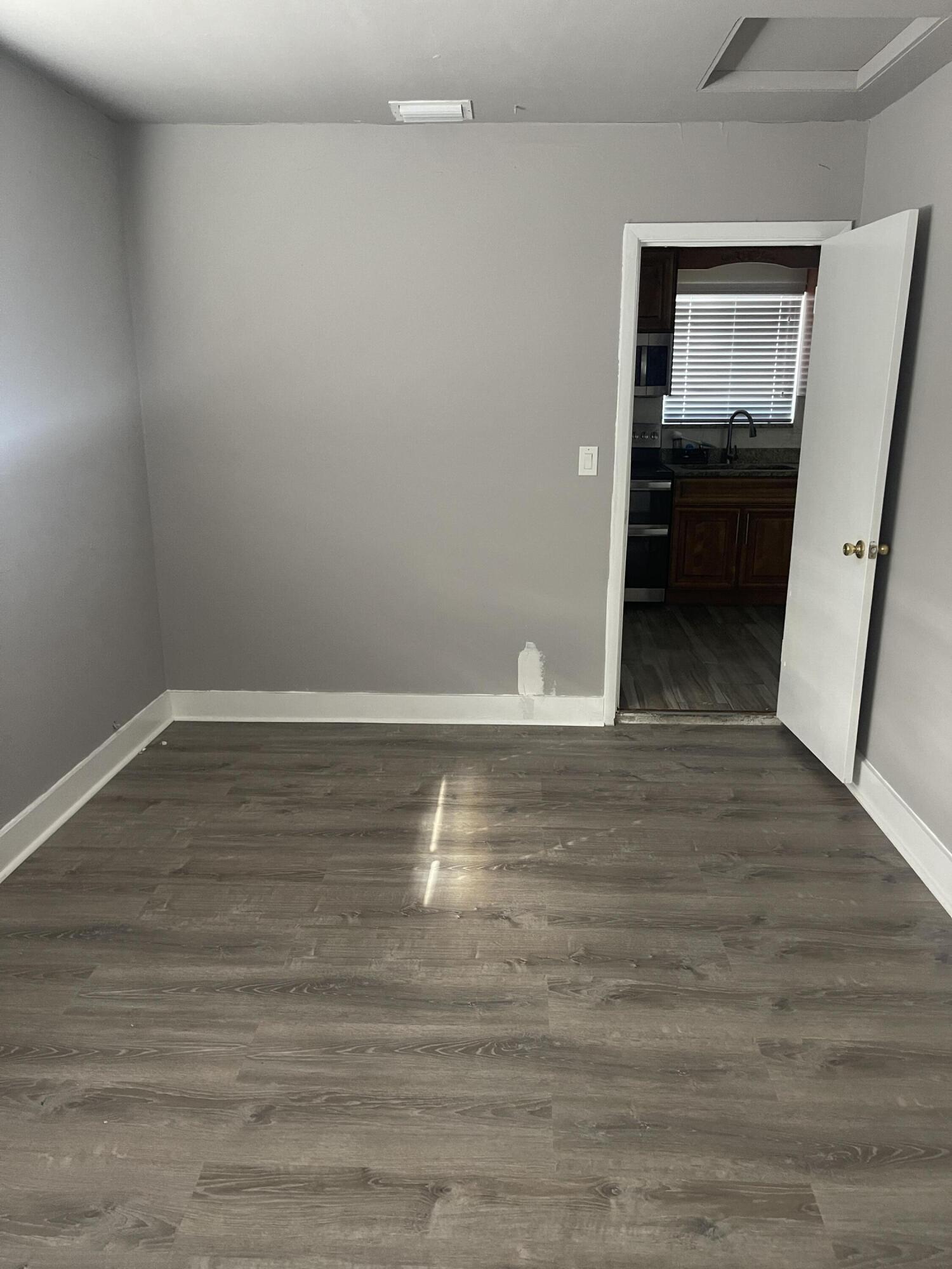 113 Northeast 5th Avenue Boynton Beach, FL 33435 - Photo 7 of 14 a view of livingroom with kitchen and wooden floor