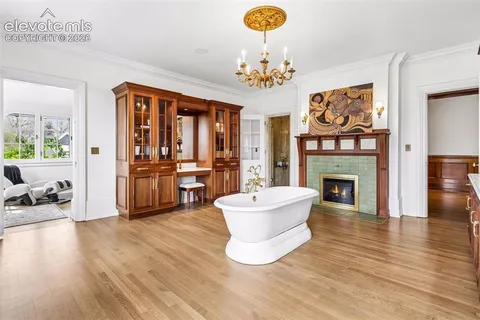 a living room with fireplace furniture and a fireplace