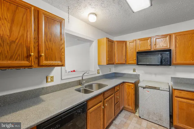 a kitchen that has a sink and a stove