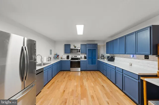 a large kitchen with stainless steel appliances kitchen island granite countertop a large counter top stainless steel appliances and cabinets