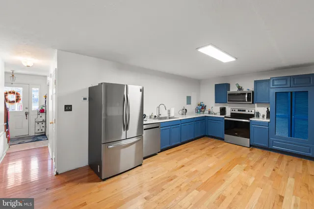 a kitchen with stainless steel appliances granite countertop a refrigerator and a stove