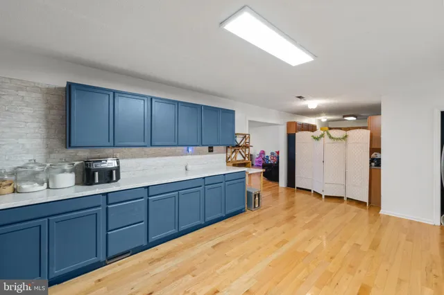 a view of a kitchen with wooden floor and electronic appliances