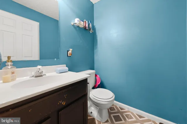 a bathroom with a sink a toilet and mirror