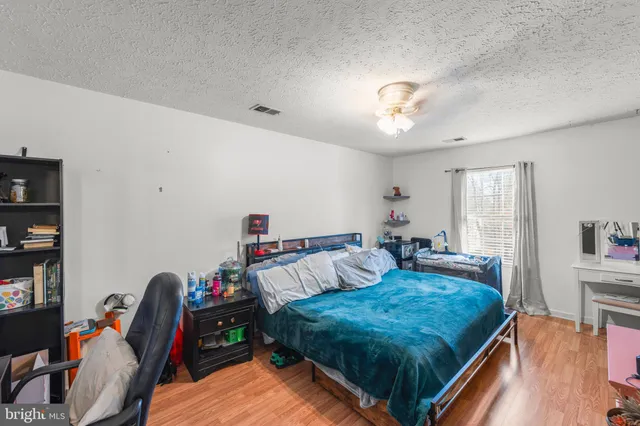 a living room with furniture fireplace and wooden floor