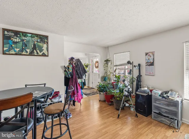 a view of a workspace with furniture and wooden floor