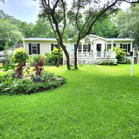 a front view of a house with a yard table and chairs