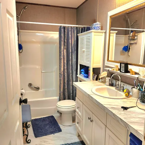 a bathroom with a sink a toilet and a bathtub