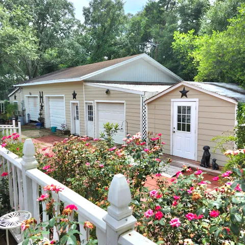 a front view of house with flowers