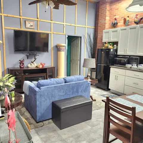 a living room with furniture and a flat screen tv