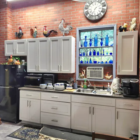 a kitchen with stainless steel appliances a sink and cabinets
