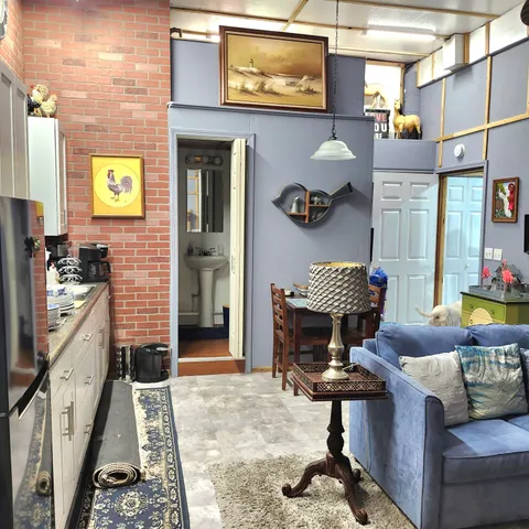 a living room with furniture a rug and a fireplace