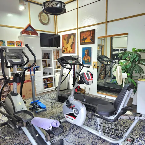 a storage room with furniture a rug and white walls