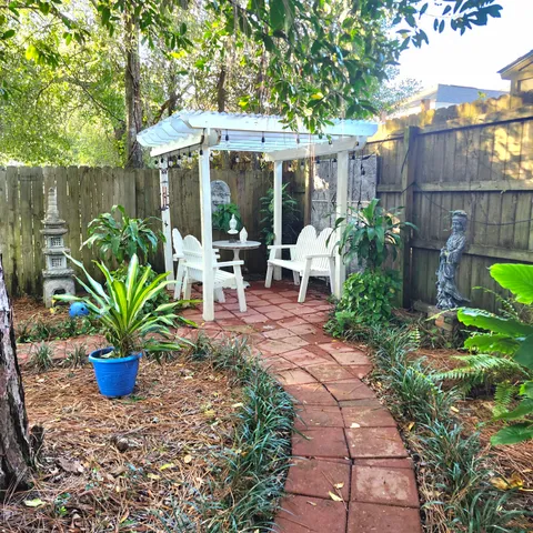 a view of a house with a backyard and a patio