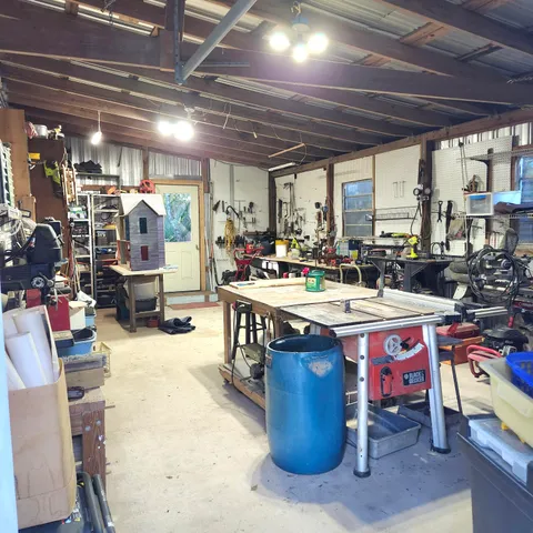 a room with lots of wooden furniture and a chandelier